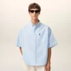 Cămașă albastră din bumbac, croială dreaptă, cu broderie Ami de Coeur Cămașă albastră din bumbac, croială dreaptă, cu broderie Ami de Coeur