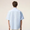 Cămașă albastră din bumbac, croială dreaptă, cu broderie Ami de Coeur Cămașă albastră din bumbac, croială dreaptă, cu broderie Ami de Coeur