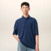 Tricou polo albastru din bumbac cu patch-uri tricotate Ami de Coeur Tricou polo albastru din bumbac cu patch-uri tricotate Ami de Coeur