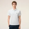 Tricou polo Ami de Coeur din bumbac alb, cu mâneci scurte Tricou polo Ami de Coeur din bumbac alb, cu mâneci scurte
