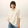 Tricou polo Ami de Coeur din bumbac alb, cu patch-uri tricotate Tricou polo Ami de Coeur din bumbac alb, cu patch-uri tricotate
