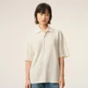 Tricou polo Ami de Coeur din bumbac alb, cu patch-uri tricotate Tricou polo Ami de Coeur din bumbac alb, cu patch-uri tricotate