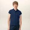 Tricou polo Ami de Coeur din bumbac albastru cu mâneci scurte Tricou polo Ami de Coeur din bumbac albastru cu mâneci scurte