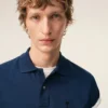 Tricou polo Ami de Coeur din bumbac albastru cu mâneci scurte Tricou polo Ami de Coeur din bumbac albastru cu mâneci scurte