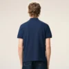 Tricou polo Ami de Coeur din bumbac albastru cu mâneci scurte Tricou polo Ami de Coeur din bumbac albastru cu mâneci scurte