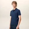 Tricou polo Ami de Coeur din bumbac albastru cu mâneci scurte Tricou polo Ami de Coeur din bumbac albastru cu mâneci scurte