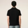 Tricou polo Ami de Coeur din bumbac negru cu imprimeu roșu Tricou polo Ami de Coeur din bumbac negru cu imprimeu roșu